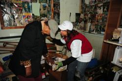 Hope Force Int'l volunteer helps a homeowner clean her flooded house after Hurricane Sandy.